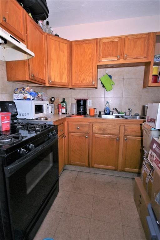 kitchen featuring sink, black range with gas stovetop, and decorative backsplash