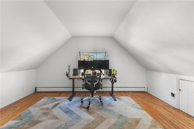 home office with light hardwood / wood-style floors and lofted ceiling