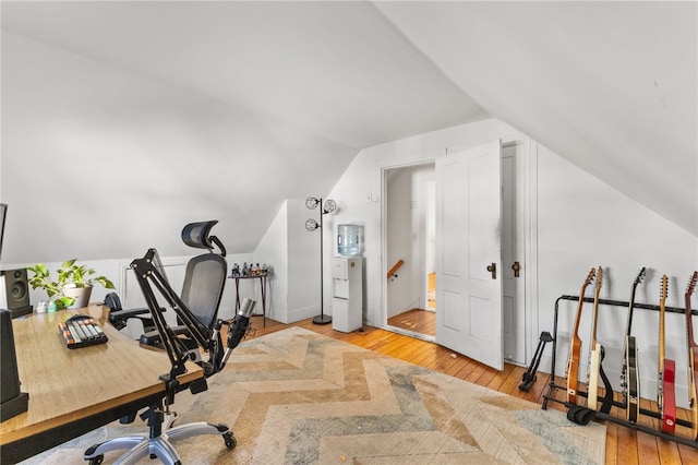 home office featuring light hardwood / wood-style floors and vaulted ceiling