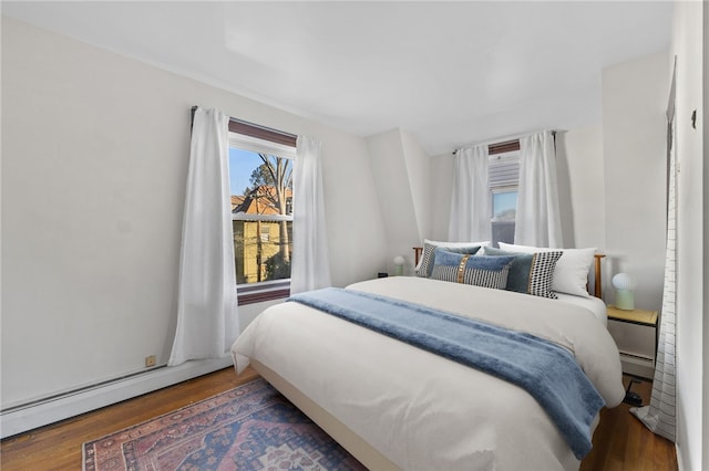 bedroom featuring dark hardwood / wood-style floors and baseboard heating