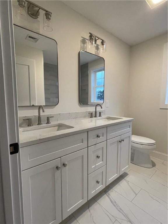 bathroom with vanity and toilet