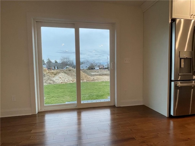 entryway with dark hardwood / wood-style floors and plenty of natural light