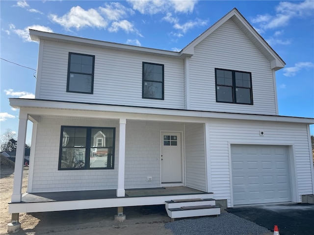 view of front of home featuring a porch and a garage