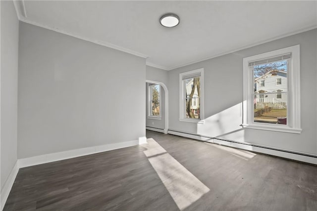 empty room featuring crown molding, plenty of natural light, a baseboard radiator, and dark hardwood / wood-style floors