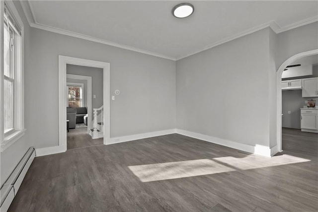 spare room featuring dark hardwood / wood-style flooring, a baseboard radiator, and ornamental molding