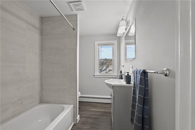 full bathroom with shower / bathtub combination with curtain, baseboard heating, wood-type flooring, toilet, and vanity