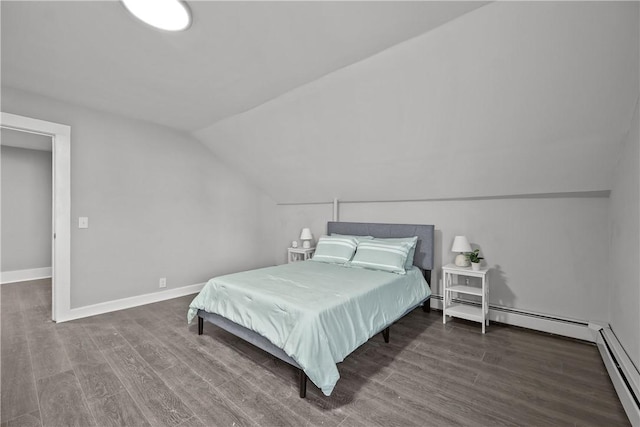 bedroom featuring dark wood-type flooring, vaulted ceiling, and a baseboard heating unit