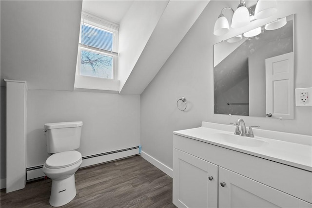 bathroom with a notable chandelier, toilet, baseboard heating, and vanity