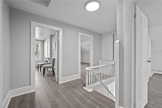 hallway featuring wood-type flooring and baseboard heating