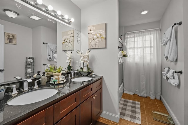 bathroom featuring tile patterned floors, vanity, and enclosed tub / shower combo