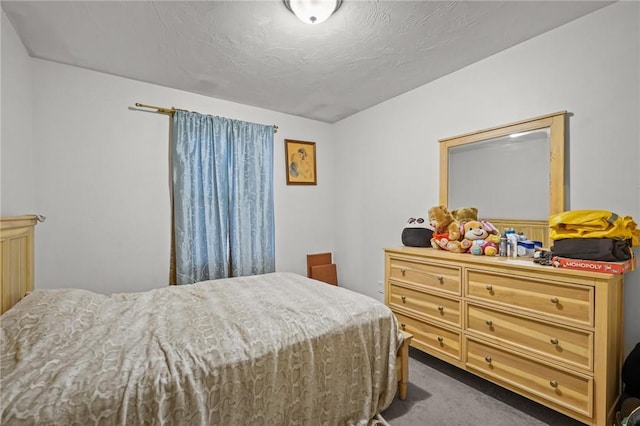 carpeted bedroom with a textured ceiling