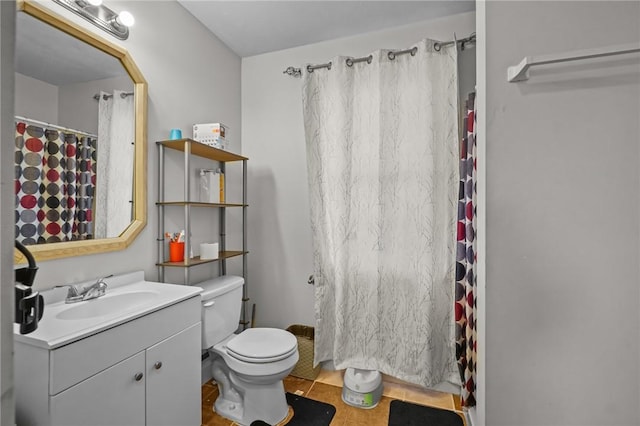 bathroom featuring tile patterned flooring, vanity, and toilet