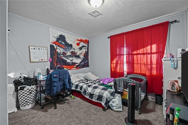 bedroom with carpet flooring and a textured ceiling