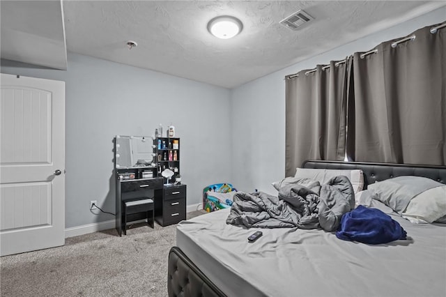 carpeted bedroom featuring a textured ceiling