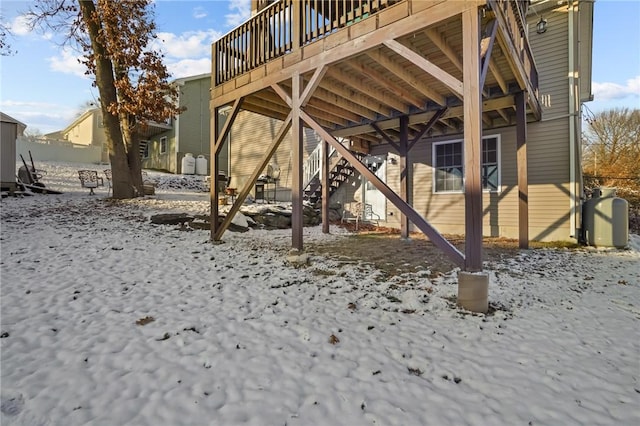 snow covered property with a wooden deck