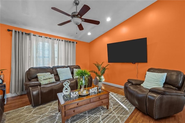 living room featuring ceiling fan, vaulted ceiling, and hardwood / wood-style flooring