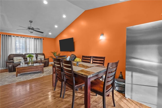 dining space featuring ceiling fan, light hardwood / wood-style floors, and lofted ceiling