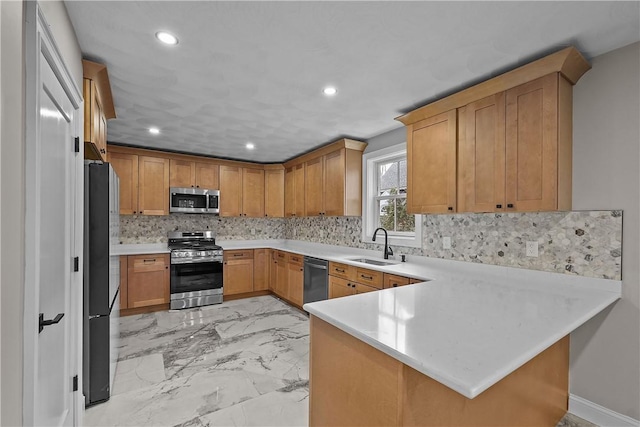 kitchen featuring kitchen peninsula, backsplash, stainless steel appliances, and sink