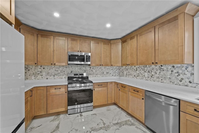 kitchen featuring appliances with stainless steel finishes and tasteful backsplash