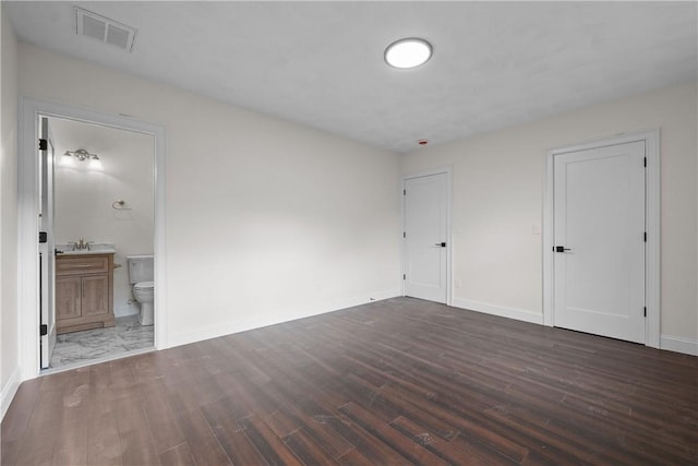 empty room with dark hardwood / wood-style flooring and sink