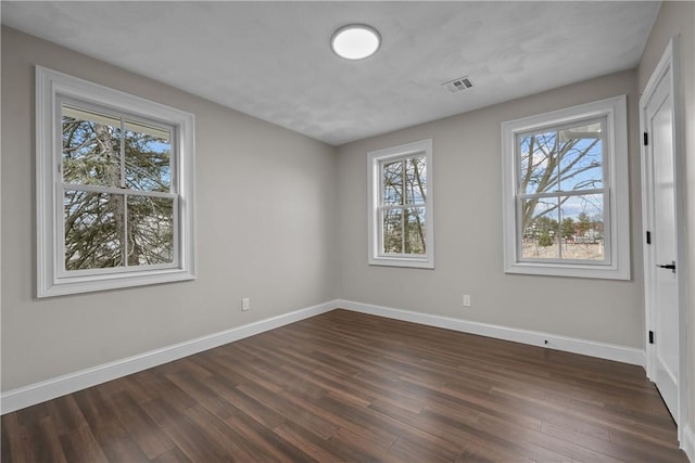 unfurnished room with dark hardwood / wood-style flooring