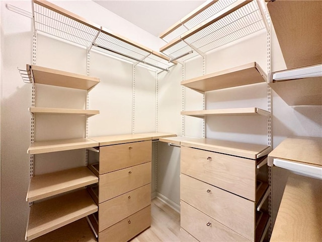 walk in closet featuring light hardwood / wood-style flooring