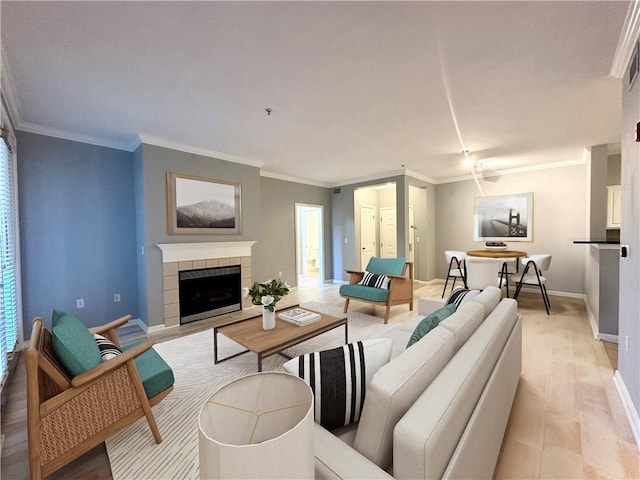 living room with crown molding and a fireplace