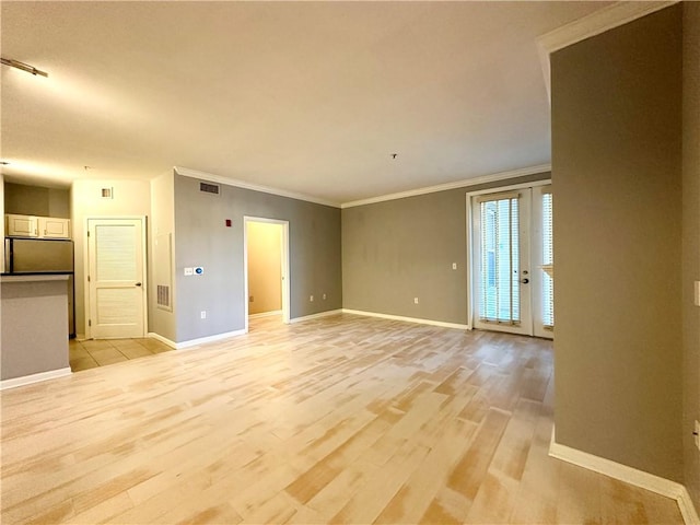 unfurnished living room with light wood-type flooring and ornamental molding