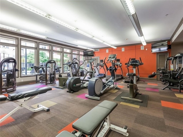 exercise room featuring dark carpet