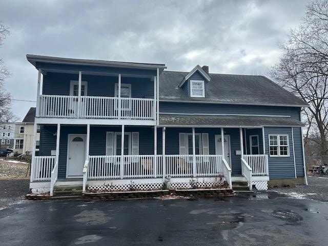 view of front of home with a balcony and a porch