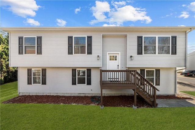 view of front of home featuring a wooden deck and a front yard