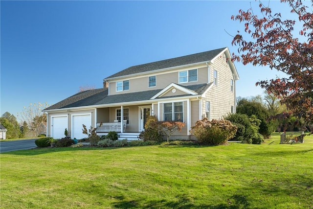 view of front of home with a front yard, a porch, and a garage