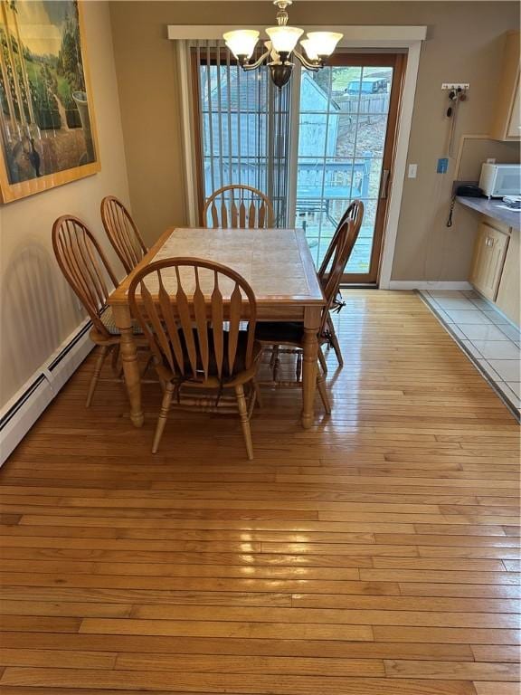 dining room featuring light hardwood / wood-style floors, plenty of natural light, and a notable chandelier