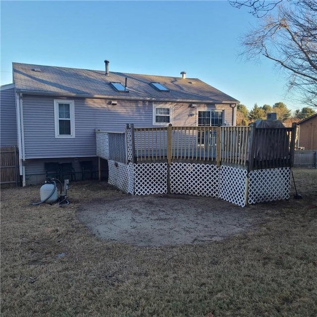 rear view of property featuring a deck