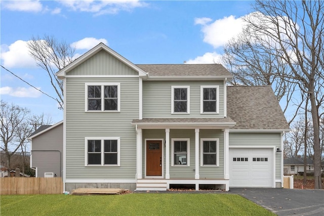 view of front of house featuring a front lawn and a garage