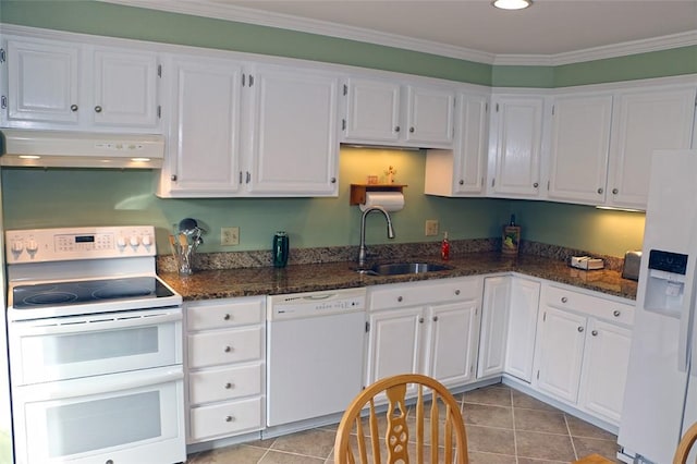 kitchen featuring sink, white appliances, white cabinetry, ornamental molding, and dark stone counters