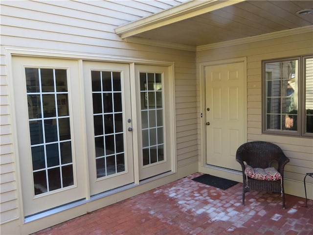 property entrance featuring a patio and french doors