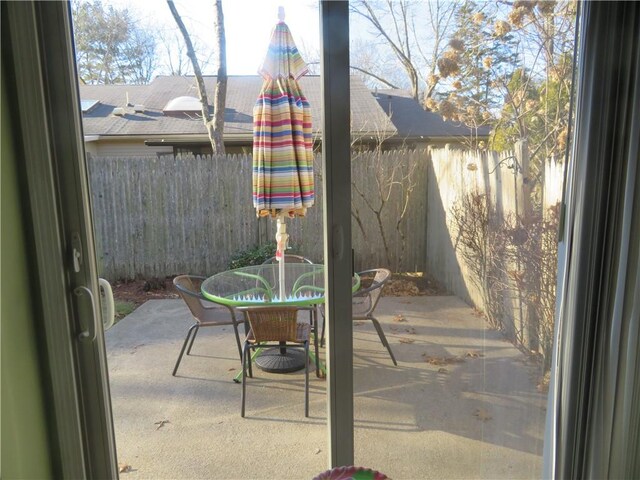 view of patio with outdoor dining area and fence