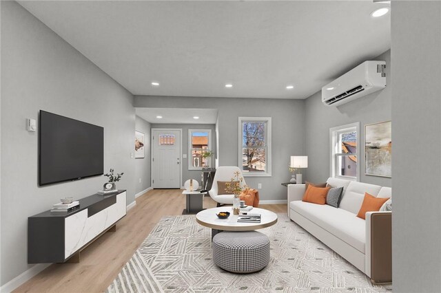 living room featuring a wall mounted AC and light wood-type flooring