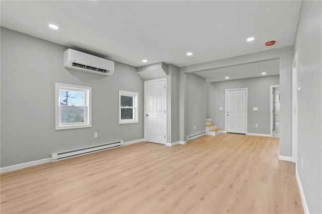 interior space featuring a wall unit AC, a baseboard radiator, and light wood-type flooring