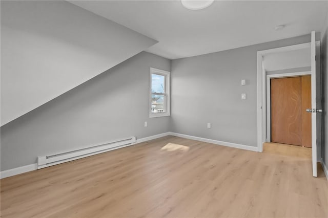 bonus room featuring lofted ceiling, a baseboard radiator, and light hardwood / wood-style floors