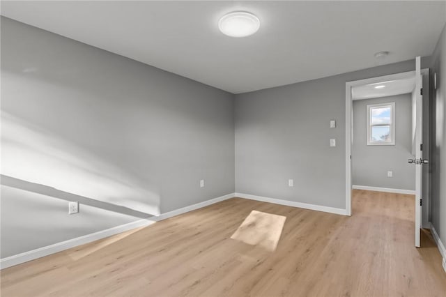 spare room with light hardwood / wood-style flooring