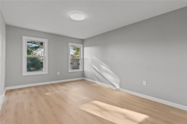 empty room with light hardwood / wood-style flooring