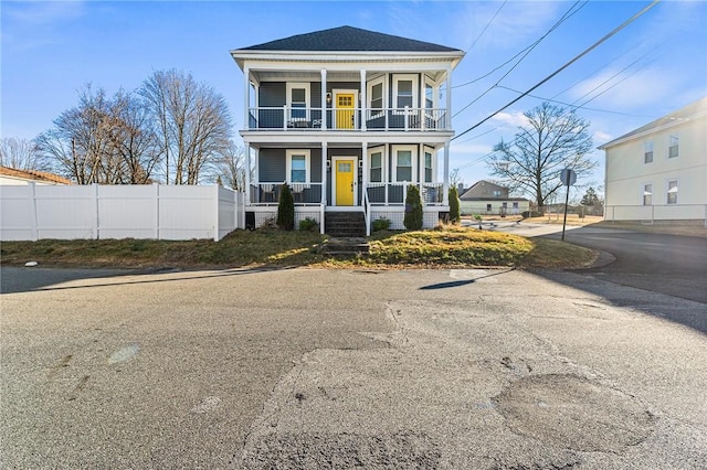 view of front of house with a porch and a balcony