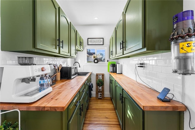 kitchen with wood counters and green cabinetry