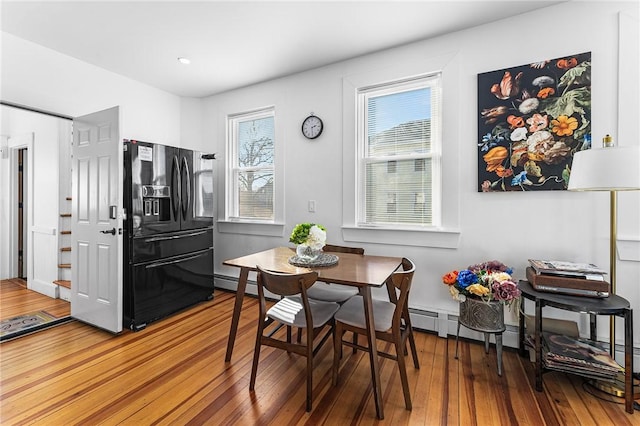 dining area featuring hardwood / wood-style flooring and a baseboard radiator