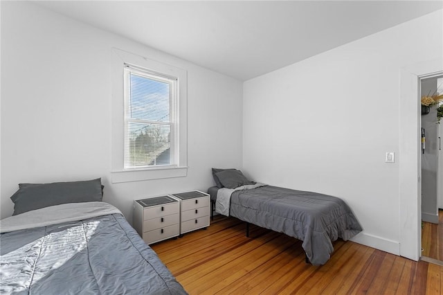 bedroom with hardwood / wood-style flooring