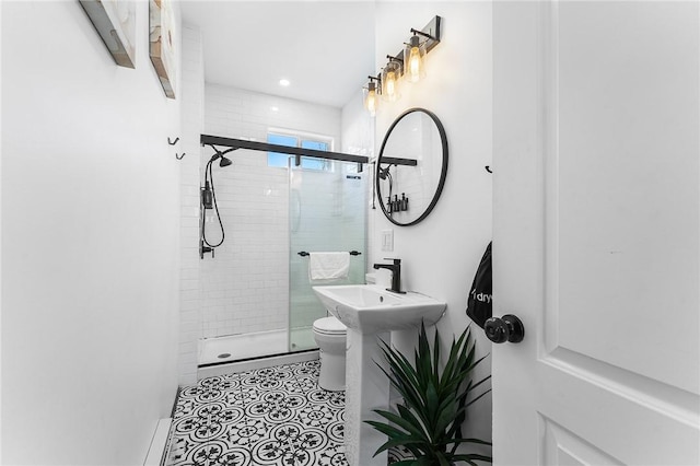 bathroom featuring tile patterned flooring, toilet, and an enclosed shower