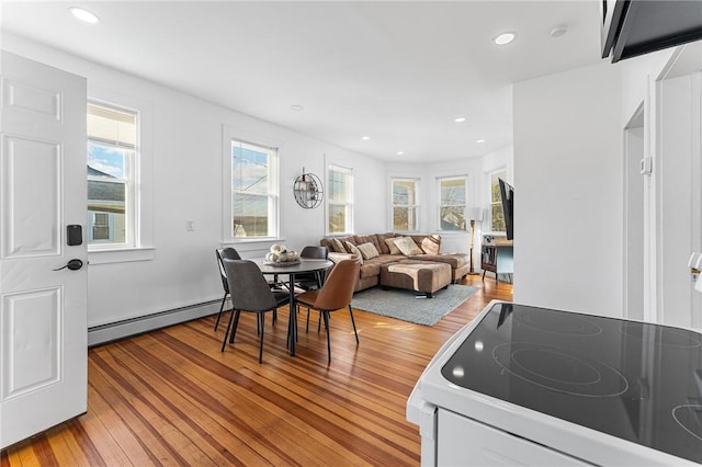 dining space featuring light wood-type flooring and a baseboard radiator