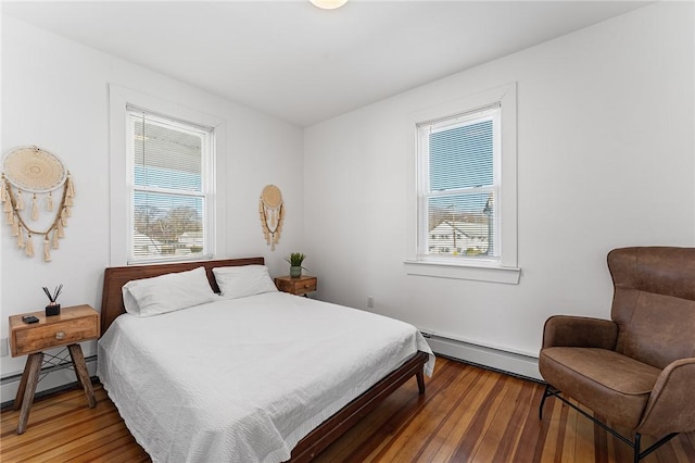 bedroom featuring a baseboard radiator and wood-type flooring